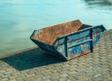 Old Worn Skip Container On Riverbank